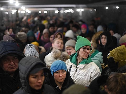 Evacuees wait in a queue to board into a train to Poland at Lviv train station, western Ukraine, on March 5, 2022.