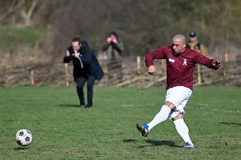 Brazilian football legend Roberto Carlos scores from the penalty spot playing a friendly match for Shrewsbury and District Sunday League side "Bull in the Barne United" outside Shrewsbury in north-west England after he was purchased by the club in an auction. 48-year-old Carlos experienced a taste of English grassroots football turning out for the team on Friday.