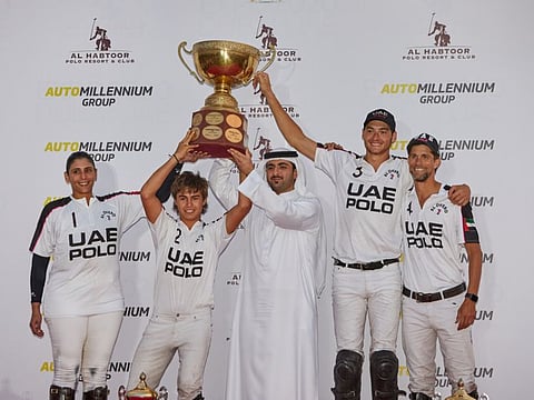 Sheikh Mohammed Bin Maktoum handing over the Dubai Gold Cup to Sheikha Maitha, Lucas Monteverde Jr, Tommy Beresford, and Jacinto Crotto after UAE Polo defeated Habtoor Polo in the final at Al Habtoor Polo, Resort and Club yesterday.