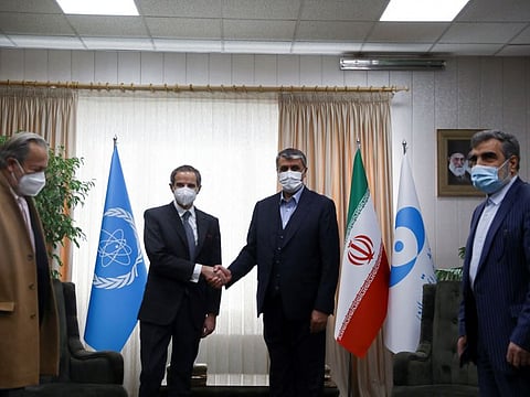 International Atomic Energy Agency (IAEA) Director-General Rafael Grossi shakes hands with Head of Iran's Atomic Energy Organisation Mohammad Eslami, in Tehran, on March 5, 2022.