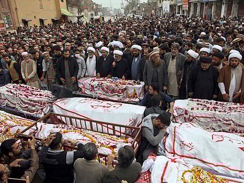 People attend the funeral prayers for the victims of suicide bombing in Peshawar, on March 5, 2022.
