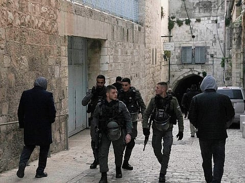 Israeli Border Police patrol in the Old City of Jerusalem as Palestinians walk to the Al Aqsa Mosque compound for prayers, on March 6, 2022. Israeli police said officers shot and killed a Palestinian attacker after he stabbed an officer in Jerusalem’s Old City.