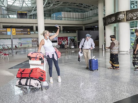 Travelers arrive at Ngurah Rai International Airport in Bali, Indonesia, on Monday, March 7, 2022.