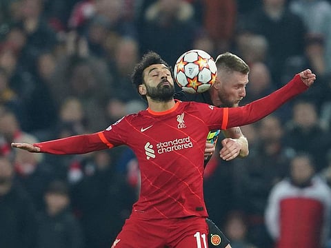 Liverpool's Mohamed Salah, left, fights for the ball with Inter Milan's Milan Skriniar.
