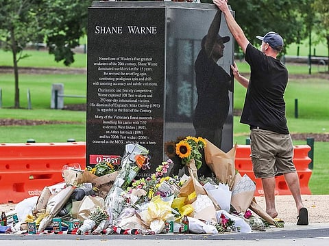 A mourner pays respects to Shane Warne outside Melbourne Cricket Ground