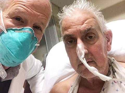 File photo: This photo released by the University of Maryland School of Medicine on January 10, 2022 shows surgeon Dr. Bartley Griffith (L) with patient David Bennett Sr., who received a heart implant from a genetically modified pig, in Baltimore, Maryland, in January 2022.