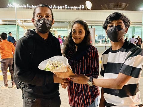 Ninin Chattarji (L) with his mother and brother after landing in Abu Dhabi on Tuesday night