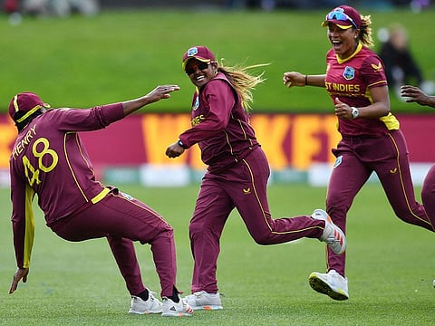 West Indies' Anisa Mohammed, Chinelle Henry and Cherry-Ann Fraser celebrate their victory over England