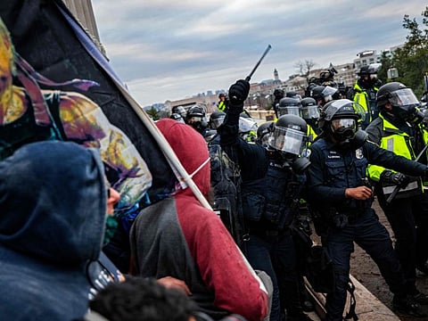 In this file photo taken on January 6, 2021, police officers attempt to push back a pro-Trump mob trying to storm the US Capitol following a rally with President Donald Trump in Washington, DC.