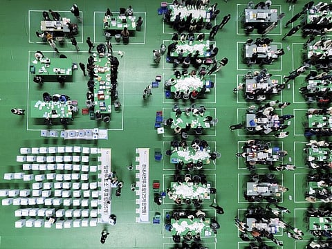 South Korean National Election Commission officials sort out ballots for counting at a gymnasium in Chuncheon, South Korea, on March 9, 2022. Exit polls released after South Korea's hard-fought presidential election on Wednesday indicated that results for the two main candidates -- an outspoken liberal governing party candidate and a conservative former top prosecutor -- were too close to call.