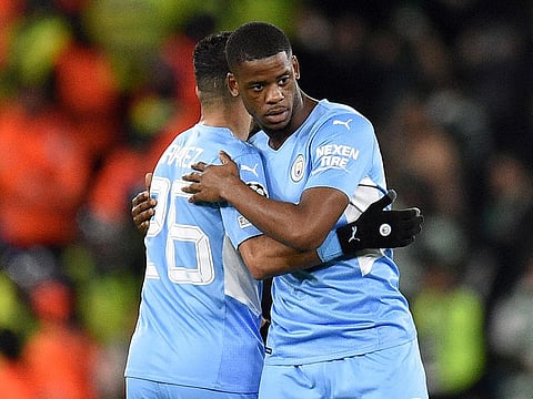 Manchester City’s Riyad Mahrez (L) hugs Luke Mbete after the aggregate victory over Sporting Lisbon.