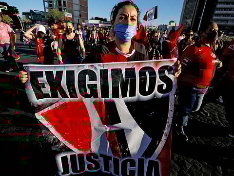 A fan of Mexican football team Atlas holds a banner reading We demand justice for the fans injured during fights following the match against Queretaro on March 5, during a march in Guadalajara, Jalisco State, Mexico. Mexico's football league has banned fans from stadiums following the weekend's violence at La Corregidora stadium in Queretaro, which left 26 people in the hospital, three of them in serious condition.