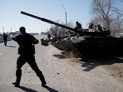Ukrainian servicemen drive off in a Russian tank they captured after fighting with Russian troops, outside Brovary, near Kyiv.