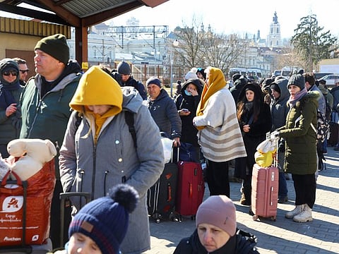 People wait for a train to Lviv, after Russia's invasion of Ukraine, in Przemysl, Poland, March 11, 2022.