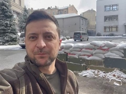 Ukrainian President Volodymyr Zelenskiy appears in a video statement with sand bags behind him, in Kyiv, Ukraine March 8, 2022 in this still image obtained from social media.
