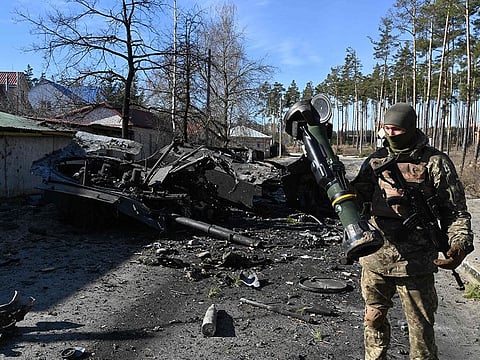 A Ukrainian soldier holds a Next Generation Light Anti-tank Weapon (NLAW) that was used to destroy a Russian armoured personal carrier (APC) in Irpin, north of Kyiv, on March 12, 2022.
