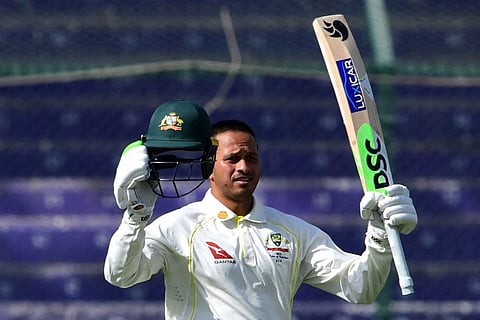 Australia's Usman Khawaja celebrates after scoring a century during the first day of the second Test match between Pakistan and Australia at the National Cricket Stadium in Karachi.
