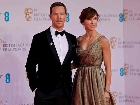 British actor Benedict Cumberbatch and his wife Sophie Hunter pose on the red carpet upon arrival at the BAFTA British Academy Film Awards at the Royal Albert Hall, in London, on March 13, 2022.