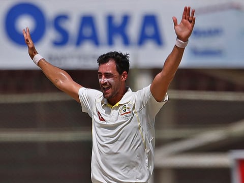 Mitchell Starc celebrates after taking the wicket of Pakistan's Fawad Alam during third day of the second Test in Karachi on Monday.