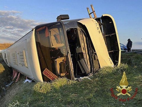 A bus lies on its side after overturning near Forli, Italy, Sunday, March 13, 2022.