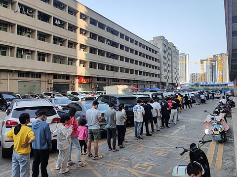 Residents queueing to undergo nucleic acid tests for the Covid-19 coronavirus in Shenzhen, in China's southern Guangdong province, on March 13, 2022. AFP