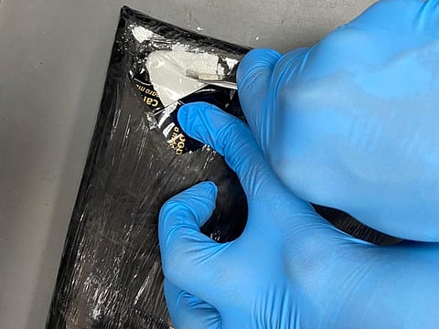 An x-ray screening spotted an abnormal density at the bottom of the lady’s suitcase