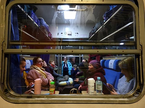 Refugees sit inside a train to Berlin at the main train station in Krakow, Poland, March 15, 2022.