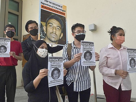 Activists hold posters against the execution of Nagaenthran K. Dharmalingam, sentenced to death for trafficking heroin into Singapore, outside the Singapore High Commision in Kuala Lumpur on March 9, 2022.