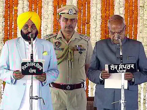 Punjab Governor Banwarilal Purohit administers the oath of office to Aam Aadmi Party leader Bhagwant Mann as Punjab Chief Minister, in Khatkar Kalan on Wednesday.