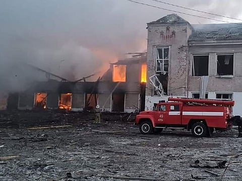 Firemen work to extinguish a fire at an educational institution hit by shelling in the town of Merefa in the Kharkiv region.