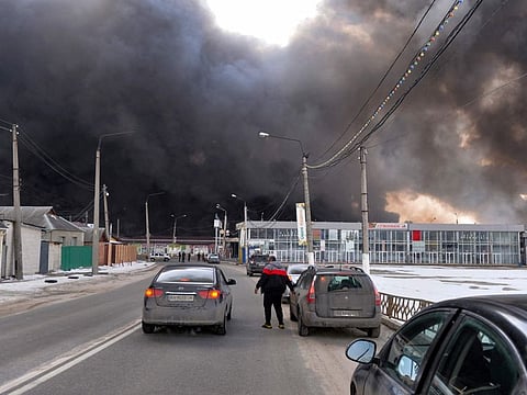 Smoke rises from the Barabashovo market - one of the largest in the eastern Europe covering an area of more than 75 hectares - which is reportedly hit by shelling, in Kharkiv on March 17, 2022.