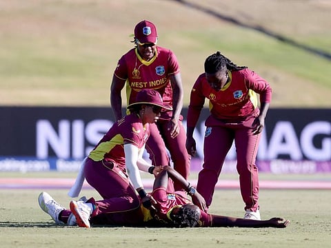 West Indian pacer Shamilia Connell (centre) receives attention from teammates after collapsing on the field during the 2022 Women's Cricket World cup match against Bangladesh at Bay Oval in Tauranga on Friday.