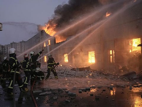 2022: Ukrainian firefighters extinguish a blaze at a warehouse after a massive bombing in Kyiv, Ukraine