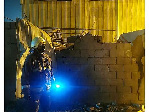A Saudi Civil Defence member is seen at the site of an earlier drone attack by Yemen's Iran-aligned Houthi group that targeted the Al Shaqeeq desalination plant and the Aramco facility, in Jizan, March 20, 2022.