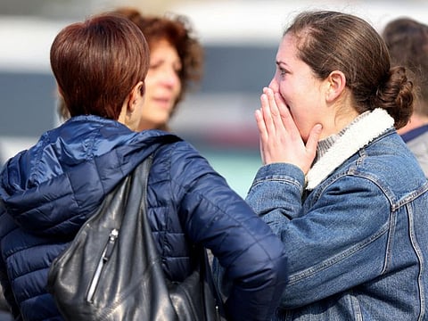 A woman reacts after a vehicle drove into a group of Belgian carnival performers who were preparing for a parade in the village of Strepy-Bracquegnies, Belgium March 20, 2022.