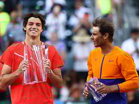 Taylor Fritz (left) of the United States holds his winners trophy after his straight sets victory against Rafael Nadal of Spain in the men's Final on Day 14 of the BNP Paribas Open at the Indian Wells Tennis Garden in Indian Wells, California.