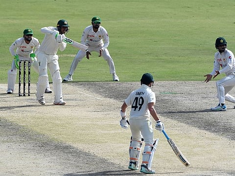 Australia's Usman Khawaja (second left) watches the ball after playing a shot during the first day of the third and final Test match between Pakistan and Australia at the Gaddafi Cricket Stadium in Lahore.