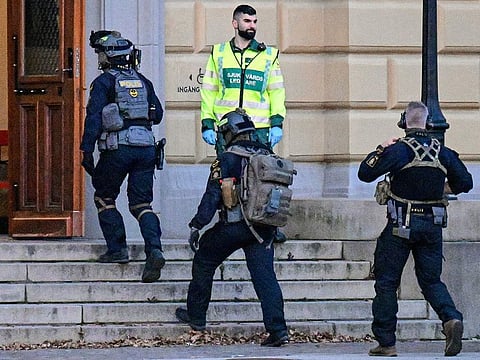 Police commandos enter a building at the scene of a reported shooting at a school in Malmoe, Sweden on March 21, 2022 which left several people wounded.