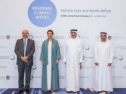 Officials pose for a group picture at a press conference in Dubai announcing first-ever 'MENACW22' summit to be held in region