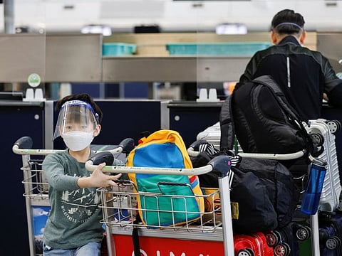 A child looks on at the check-in counters of the Hong Kong International Airport in Hong Kong.