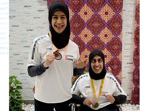 Shot putter Noura Alketbi, right, with her gold medal alongside bronze medallist Thekra Alkaabi