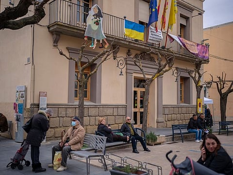 A Ukrainian flag is displayed on the Town Hall of the village of Guissona in Lleida, Spain. In Guissona, refugees aren’t just staying with their relatives. Familiarity with the Ukrainian community bred local sympathy for the refugees’ plight, and Spaniards are making room for them too.