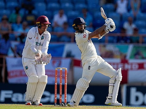 England's Saqib Mahmood hits a four against West Indies during day one of their third Test cricket match at the National Cricket Stadium in St. George, Grenada, Thursday, March 24, 2022.