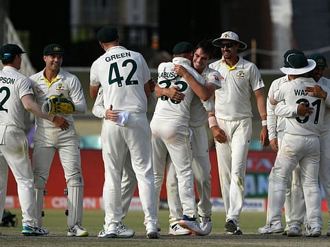 Australia's players celebrate their win in the third and final Test cricket match against Pakistan at the Gaddafi Cricket Stadium in Lahore.