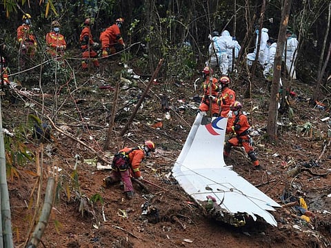In this photo released by Xinhua News Agency, search and rescue workers conduct search for the black box near the debris at the China Eastern flight crash site in Tengxian County in southern China's Guangxi Zhuang Autonomous Region on Thursday, March 24, 2022.
