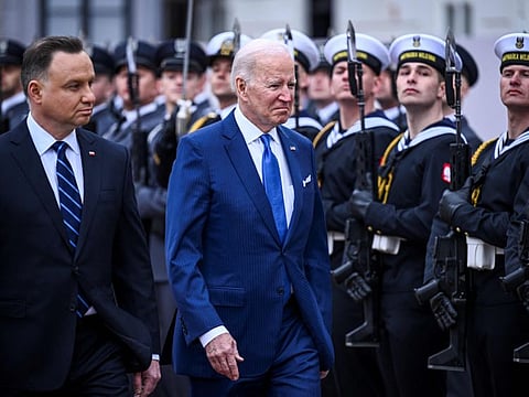 US President Joe Biden and Polish President Andrzej Duda review a military honour guard during an official welcoming ceremony prior to a meeting in Warsaw on March 26, 2022.