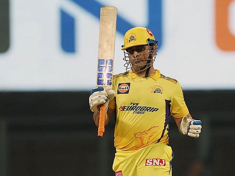 Former Indian skipper Mahendra Singh Dhoni celebrates after reaching his half-century against Kolkata on the opening day of the TATA IPL at Wankhede Stadium in Mumbai on Saturday.