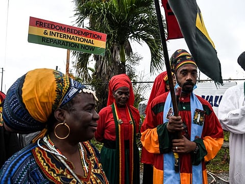 Members of Ethiopia Africa Black International Congress Church protest the visit of Britains Prince Williams and Catherine the Duchess of Cambridge outside the Sybil Strachan Primary School, in Nassau, Bahamas on March 25, 2022.