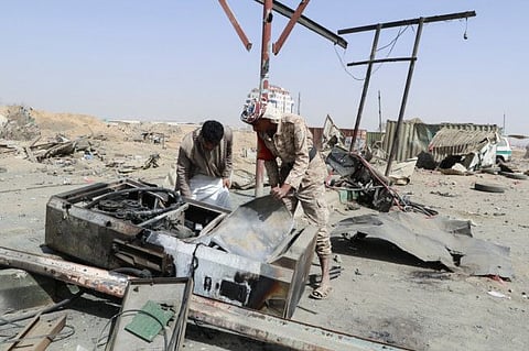 Yemenis inspect damage after a Saudi-led airstrike in Saada.