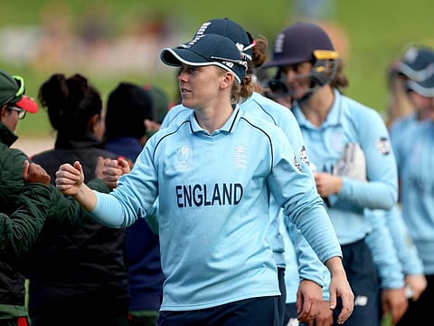 England's captain Heather Knight ecorts her team out of the field after a win during the Women's Cricket World Cup match against Bangladesh at the Basin Reserve in Wellington.